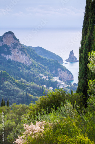 Beautiful summer seascape. View of Agios Gordios famous beach in rocky bay with crystal clear azure water on Corfu island, Ionian archipelago, Greece. photo