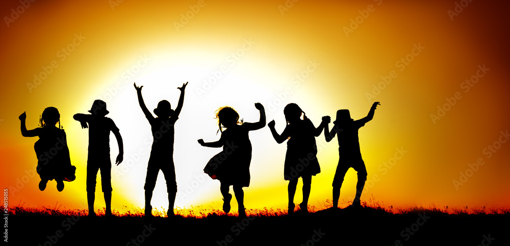 Silhouette of happy children boys and girls jumping and dancing in sunset sky evening time background as successful, happiness and careless concept Silhouette of happy children boys and girls jumping and dancing in sunset sky evening time background as successful, happiness and careless concept