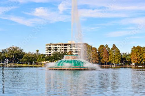 Orlando, Florida . December 25, 2018. Colorful vintage fountain , business buildings and autumn trees at Lake Eola Park in Orlando Downtown area (2) photo