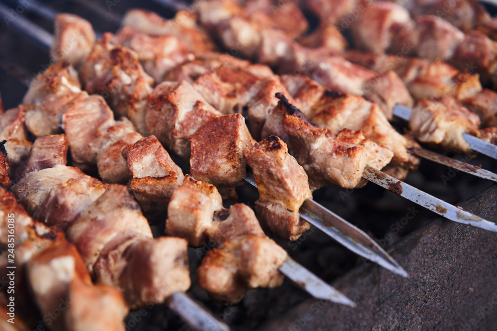 Grilling marinated shashlik on a grill. Shashlik is a form of Shish kebab popular in Europe and other places