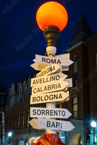 Boston sign at night leads to italy