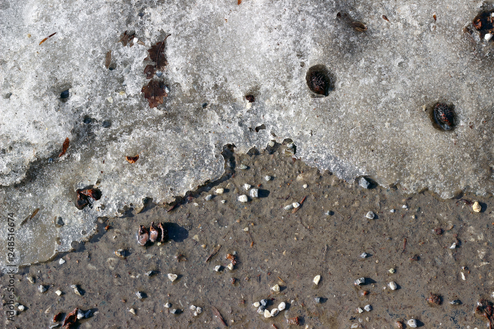 Melting snow asphalt stone grit slush road Melting snow asphalt stone grit slush road