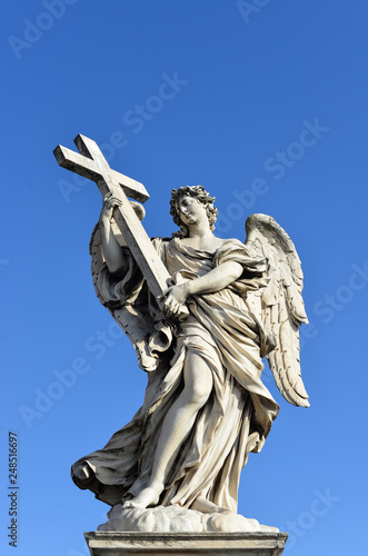 Angel holding the Holy Cross. Sant'Angelo Bridge in the center of Rome