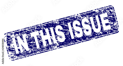 IN THIS ISSUE stamp seal print with grunge texture. Seal shape is a rounded rectangle with frame. Blue vector rubber print of IN THIS ISSUE label with unclean texture.