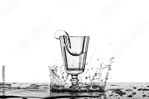 A photograph of a splash in alcohol in a vintage glass. photo