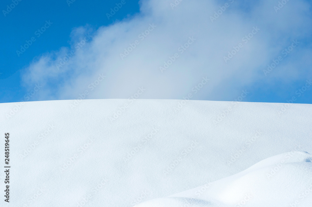 Beautiful horizon with blue sky and snowy hill.