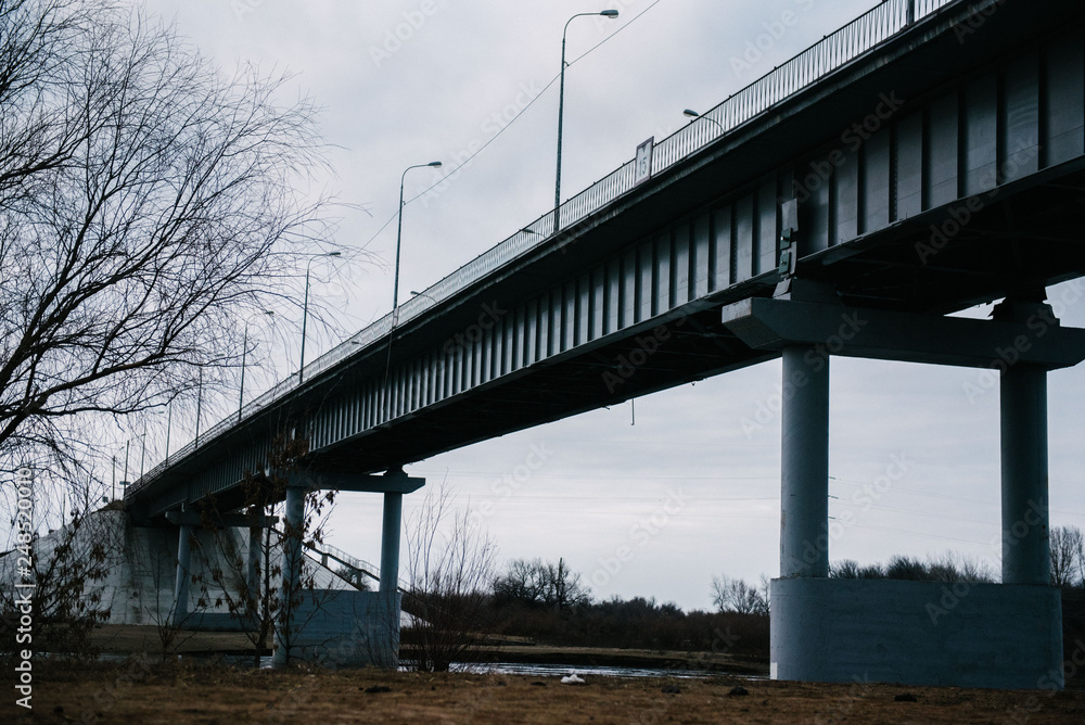 Large concrete bridge over the river in winter