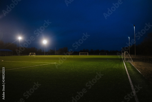 Football field at night illuminated by spotlights © bo.kvk