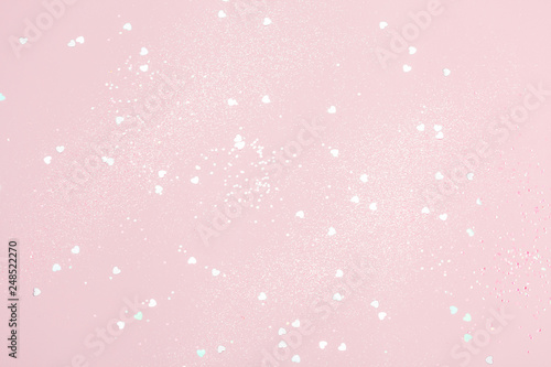 Pink confetti background. Top view, flat lay. Vibrant and festive