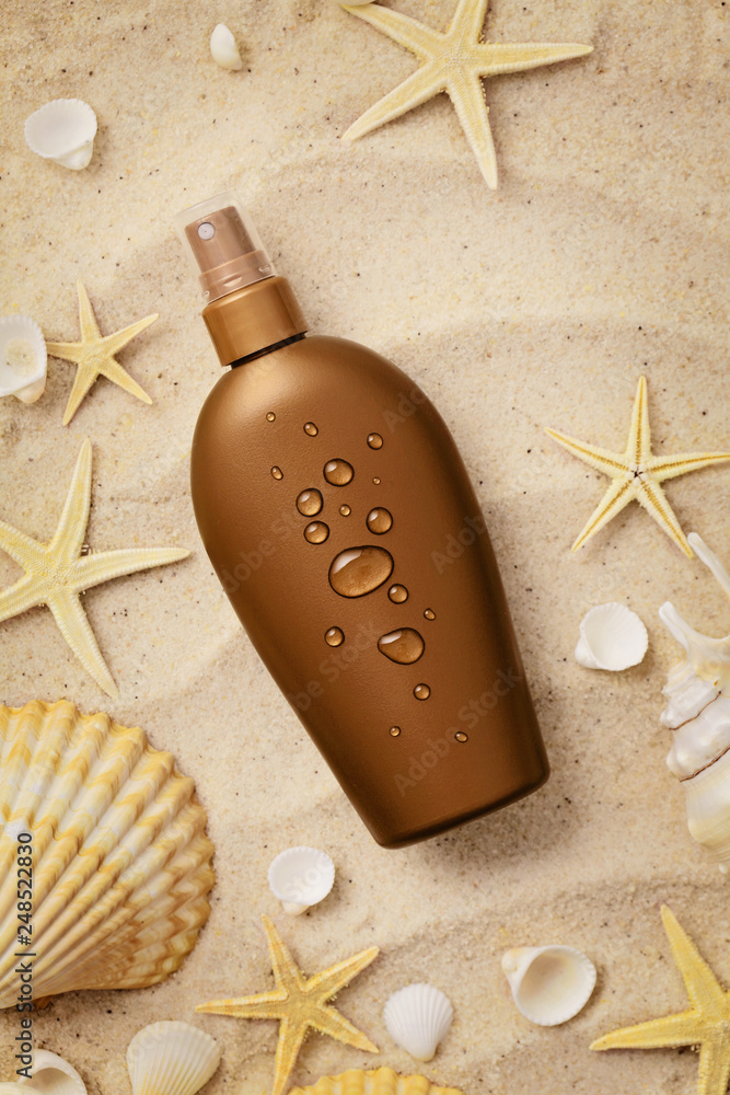 suntan lotion and seashells on the sand beach suntan lotion and seashells on the sand beach