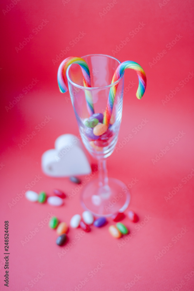Sweets in a glass on a red background. Valentine's Day