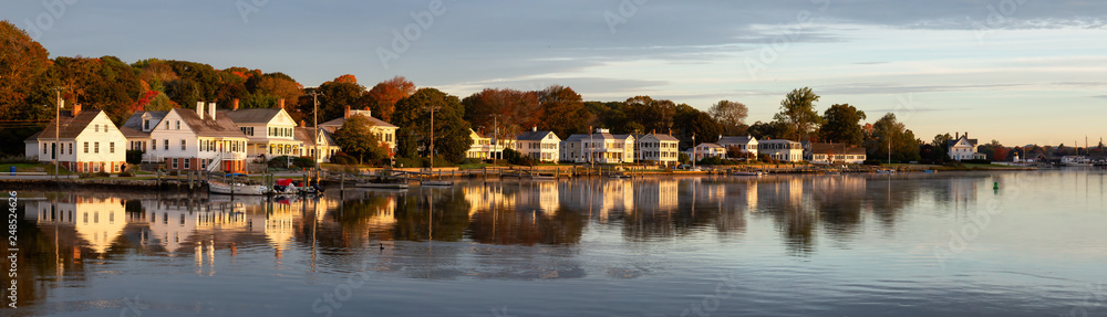 Panoramic view of residential homes by the Mystic River during a vibrant sunrise. Taken in Mystic, Stonington, Connecticut, United States.