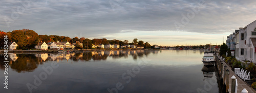 Panoramic view of residential homes by the Mystic River during a vibrant sunrise. Taken in Mystic, Stonington, Connecticut, United States. photo