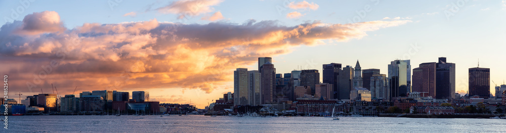 Striking panoramic cityscape of a modern Downtown City during a vibrant sunset. Taken from LoPresti Park, Boston, Capital of Massachusetts, United States.