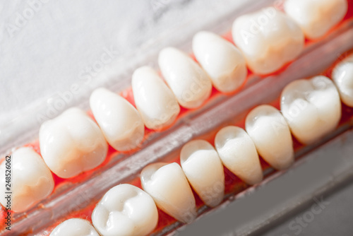 samples of human teeth  dental equipment  enamel color samples on a light background