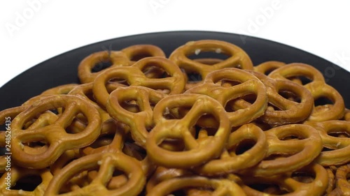 Pretzel salted in rotation. Close up. Studio shot. isolated on white. Unhealthy diet concept. Junk food concept.