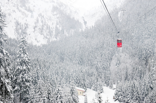 Cable car in winter alpine landscape