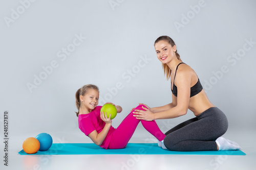 Sportive woman and 10 years old girl with slamballs
