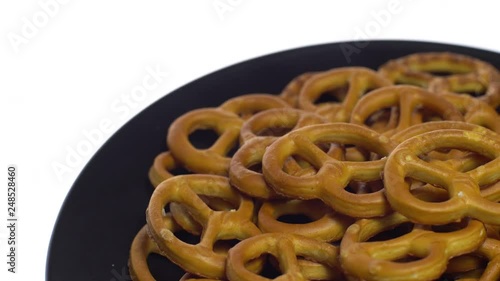 Pretzel salted in rotation. Close up. Studio shot. isolated on white. Unhealthy diet concept. Junk food concept.