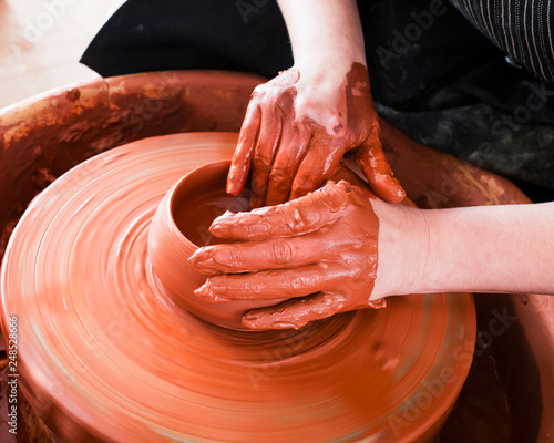 Professional potter making bowl in pottery workshop