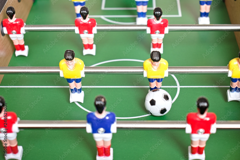 Table football game with yellow, red and blue plastic players. Table football game with yellow, red and blue plastic players.