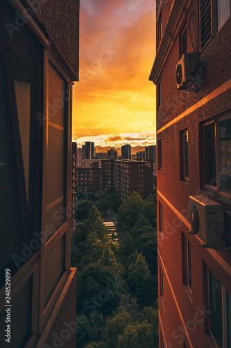 Canvas Print Looking Between Two Apartment Buildings at Cityscape Urban View Sunset Orange Re