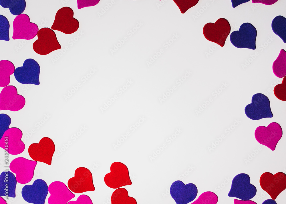 Valentine's day background. Colored little hearts on a white background. Copyspace.