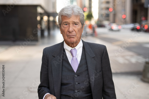 Senior businessman in city serious angry face