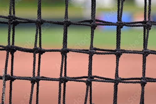 Canvas Print Closeup of net behind home plate at a baseball field