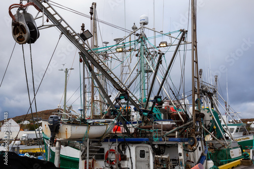 Twillingate, Newfoundland, Canada - October 15, 2018: Fishing boats parked at a marina during a cloudy morning.