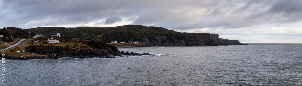 Panoramic view of a small town on the Atlantic Ocean Coast during a cloudy evening. Taken in Little Wild Cove, North Twillingate Island, Newfoundland and Labrador, Canada.