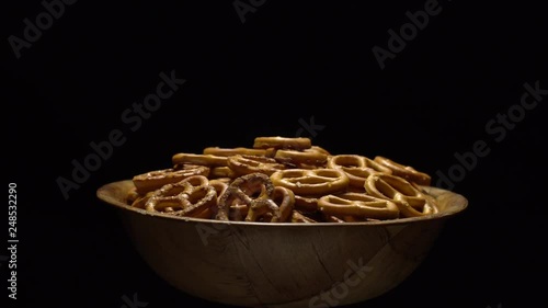 Pretzel salted in rotation. Close up. Studio shot. Black background. Unhealthy diet concept. Junk food concept.