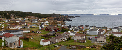 Panoramic view of a small town on the Atlantic Ocean Coast during a cloudy evning. Taken in Crow Head, North Twillingate Island, Newfoundland and Labrador, Canada.