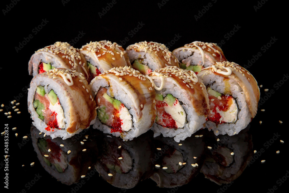 Sushi roll with smoked eel, salmon, tuna, avocado, cucumber