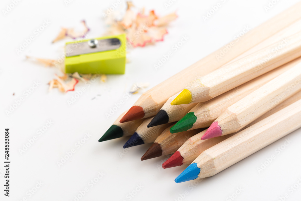 Fototapeta premium Wooden colorful pencils isolated on a white background, pencil sharpeners.