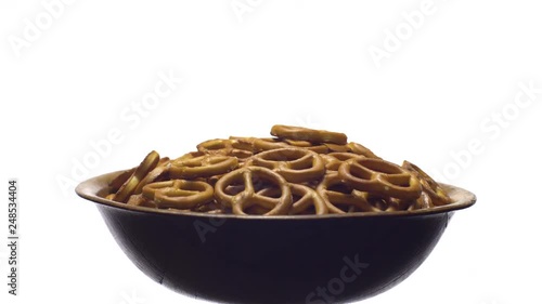 Pretzel salted in rotation. Close up. Studio shot. isolated on white. Unhealthy diet concept. Junk food concept.