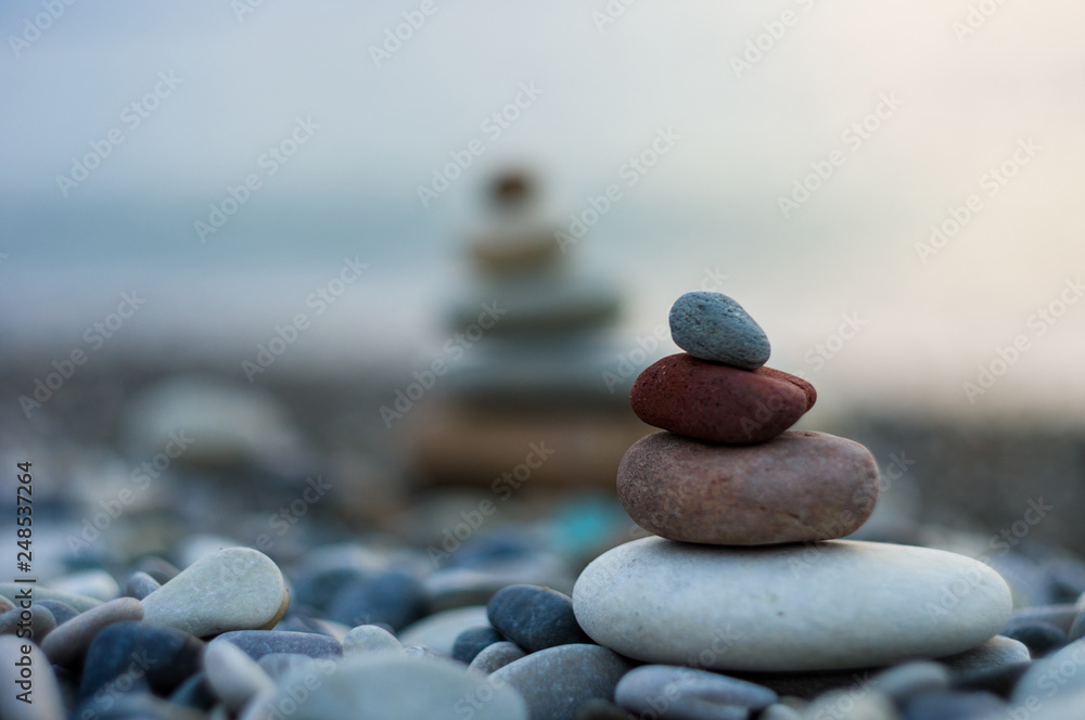 stack of zen stones on pebble beach - obrazy, fototapety, plakaty 