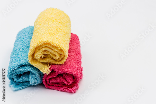 colored towels rolled up white background