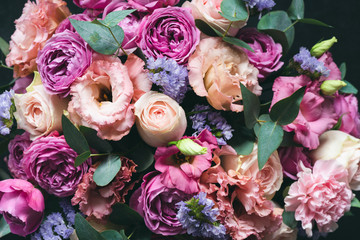 Beautiful pink and purple Peonies and roses bouquet with eucalyptus. Closeup view. Wedding or Birthday bouquet of flowers