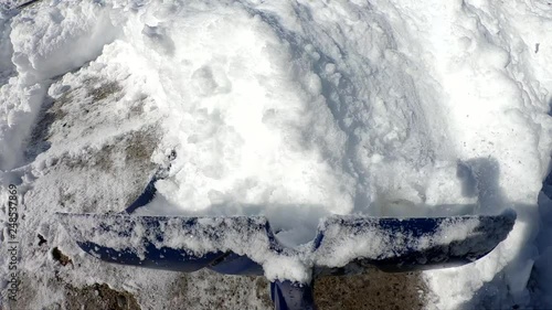 Camera mounted on tool while shoveling snow from driveway slow motion