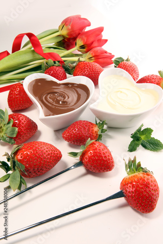 Valentine Chocolate fondue melted with fresh strawberries and dark and white chocolate. Tublips and sugar hearts.