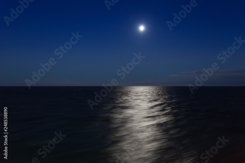 Moon above the horizon of the sea at evening
