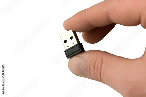  small flash drive in hand close up. Isolate