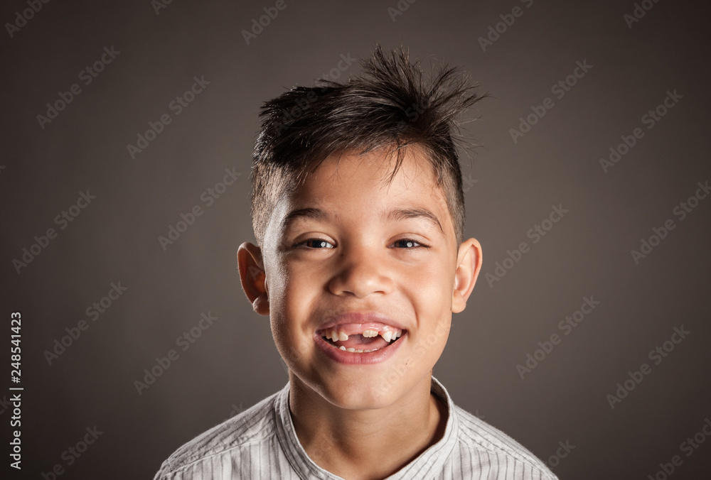 portrait of happy kid smiling on a grey background portrait of happy kid smiling on a grey background
