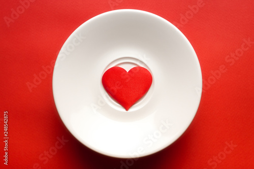 concept red heart at white dish. greeting card. copy space. relationships and humans. healthy lifestyle. for decor and design.