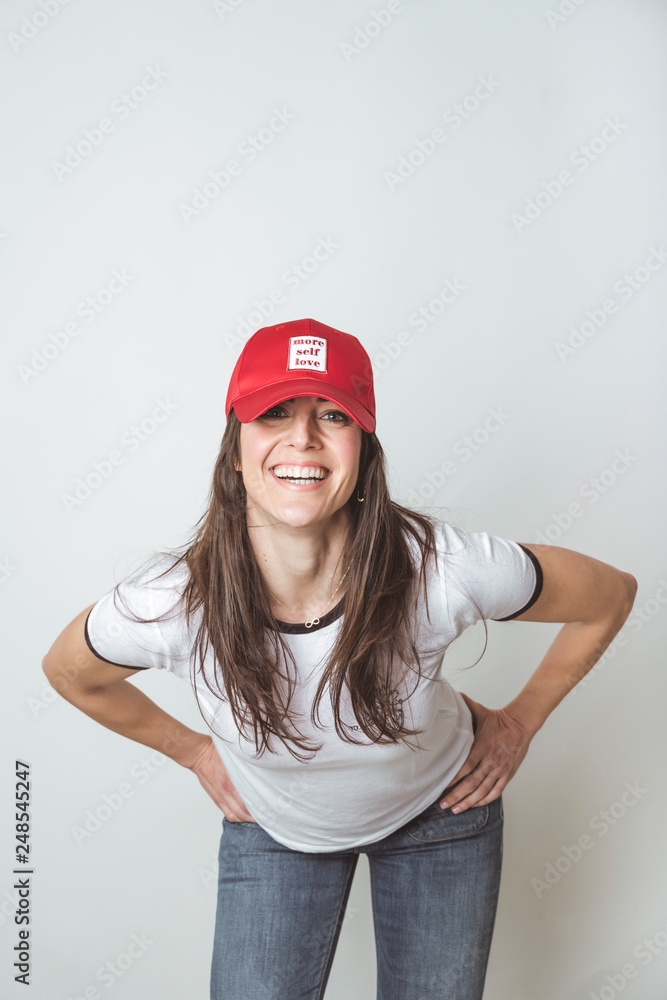 Fototapeta premium Happy beautiful woman with red hat in studio