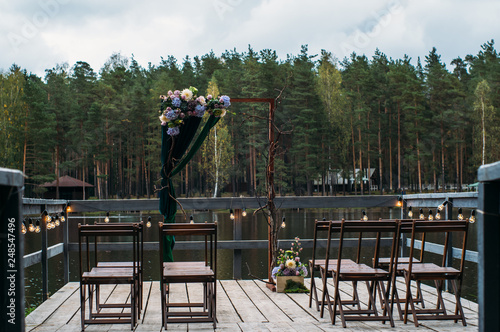 Wedding arch decorations on lake, outdoors