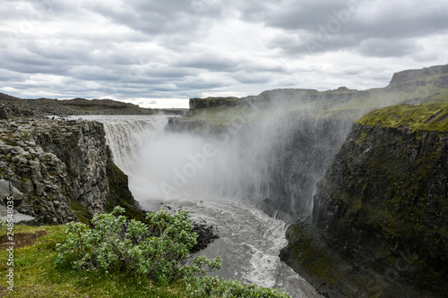Fresh clean Dettifoss waterfall in Iceland in summer with loads of water flowing and mist