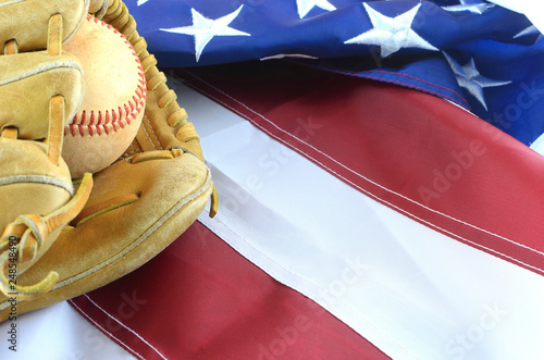 Photography Closeup of worn baseball and mitt on a US flag background, great for America's favorite pasttime