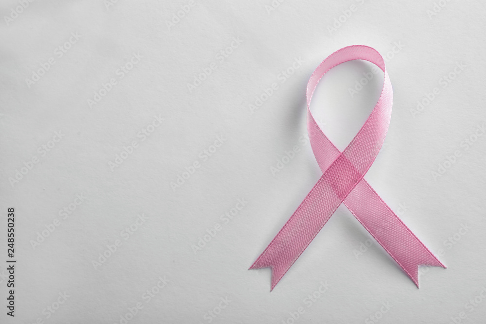 Pink ribbon on white background, top view with space for text. Breast cancer awareness concept Pink ribbon on white background, top view with space for text. Breast cancer awareness concept